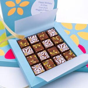 a square box of daisies and bees patterned chocolates