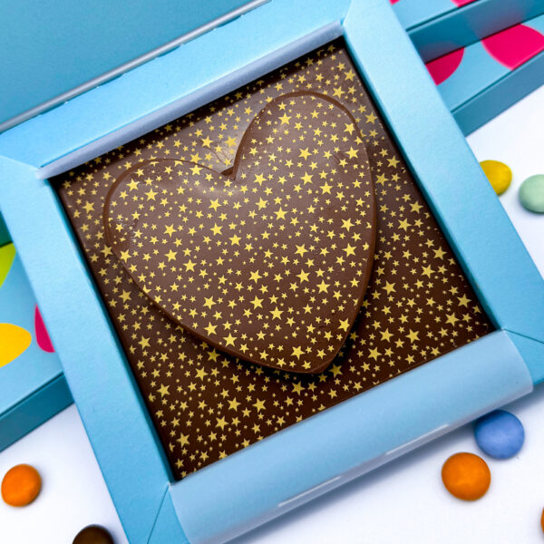 A Milk Chocolate Heart decorated with gold stars.