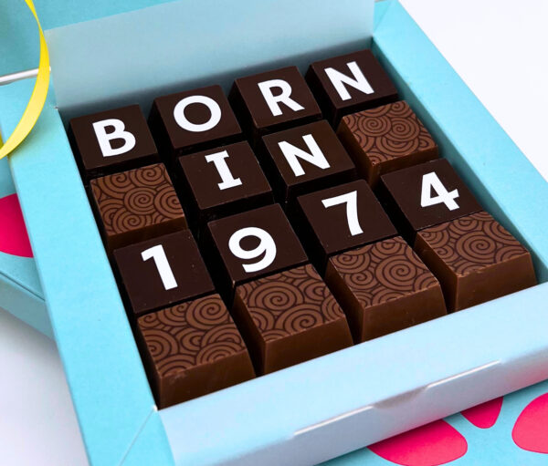 A square box of chocolates with born in 1974 on.