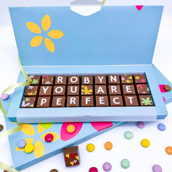 A box of solid milk chocolate blocks, which spell out the message Robyn you are perfect. Can be personalised to send to your own special someone.