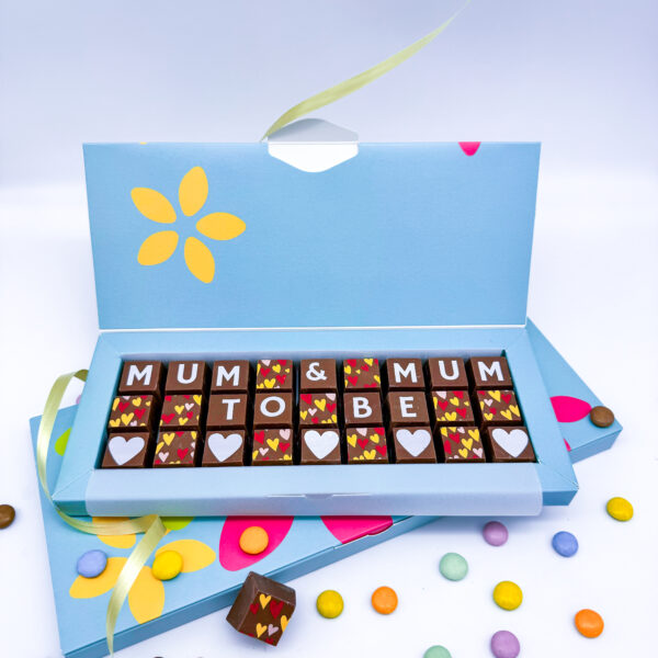 A box of solid milk chocolate blocks that spell out the message Mum & Mum to be