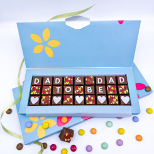 A box of solid milk chocolate blocks that spell out the message Dad & Dad to be