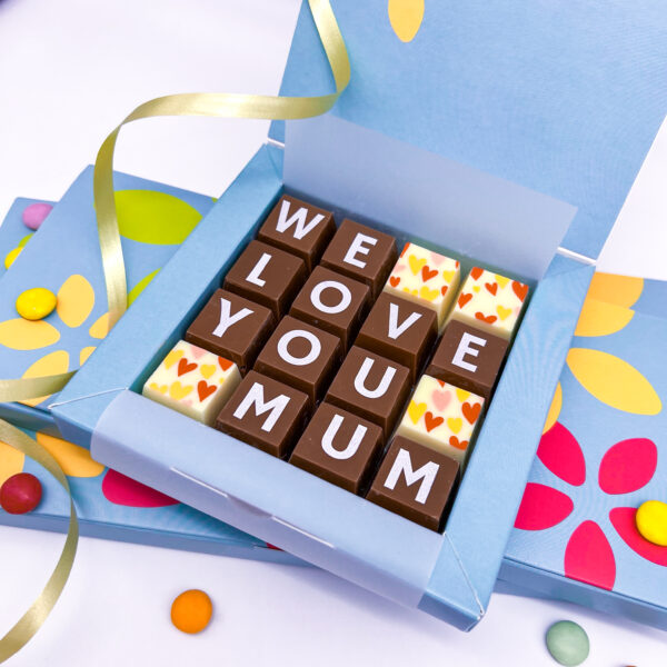 A box of solid milk and white chocolate blocks that spell out the words We Love You Mum. Can also read I love you Mum' and personalised with a special message on the inside of the lid.
