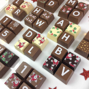 4 blocks of chocolate with Christmas Patterns and initials