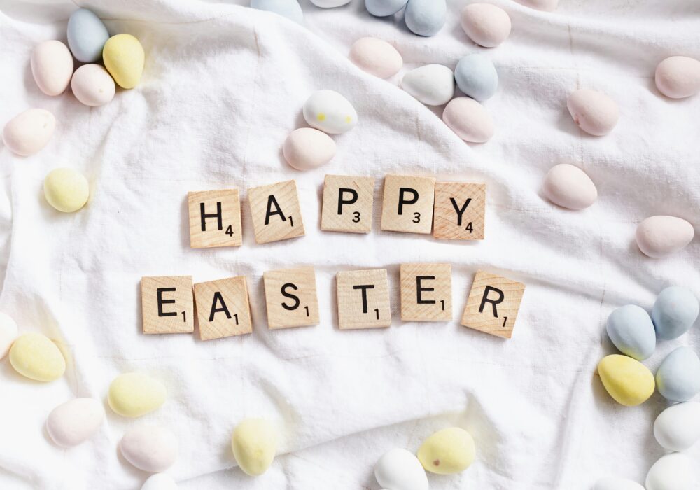 Happy Easter in scrabble letters surrounded by mini easter eggs