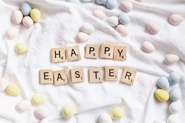 Happy Easter in scrabble letters surrounded by mini easter eggs